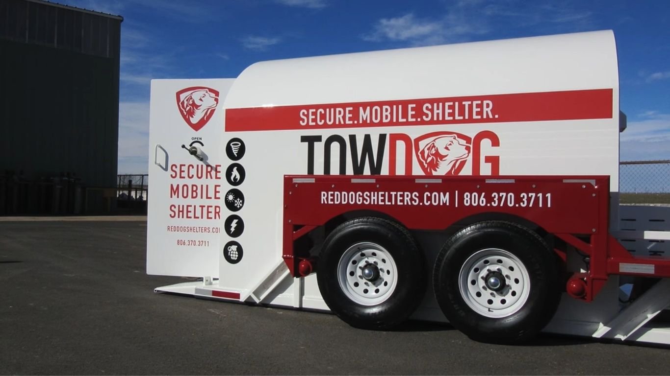 A secure, towable unit deployed on asphalt as a reliable above-ground shelter.